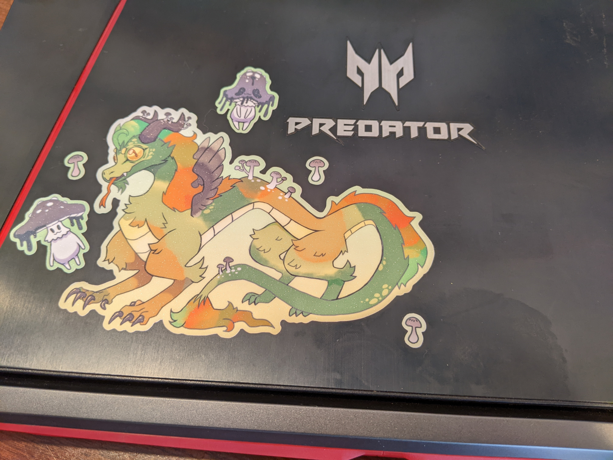 cute dragon with mushroom stickers on a laptop